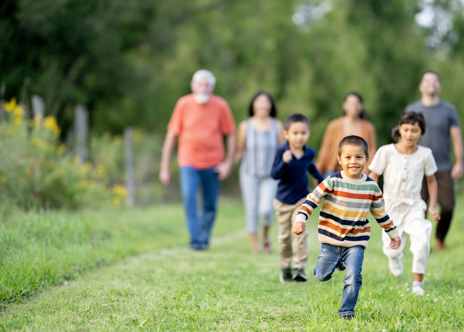 family of multiple generations walks outside together
