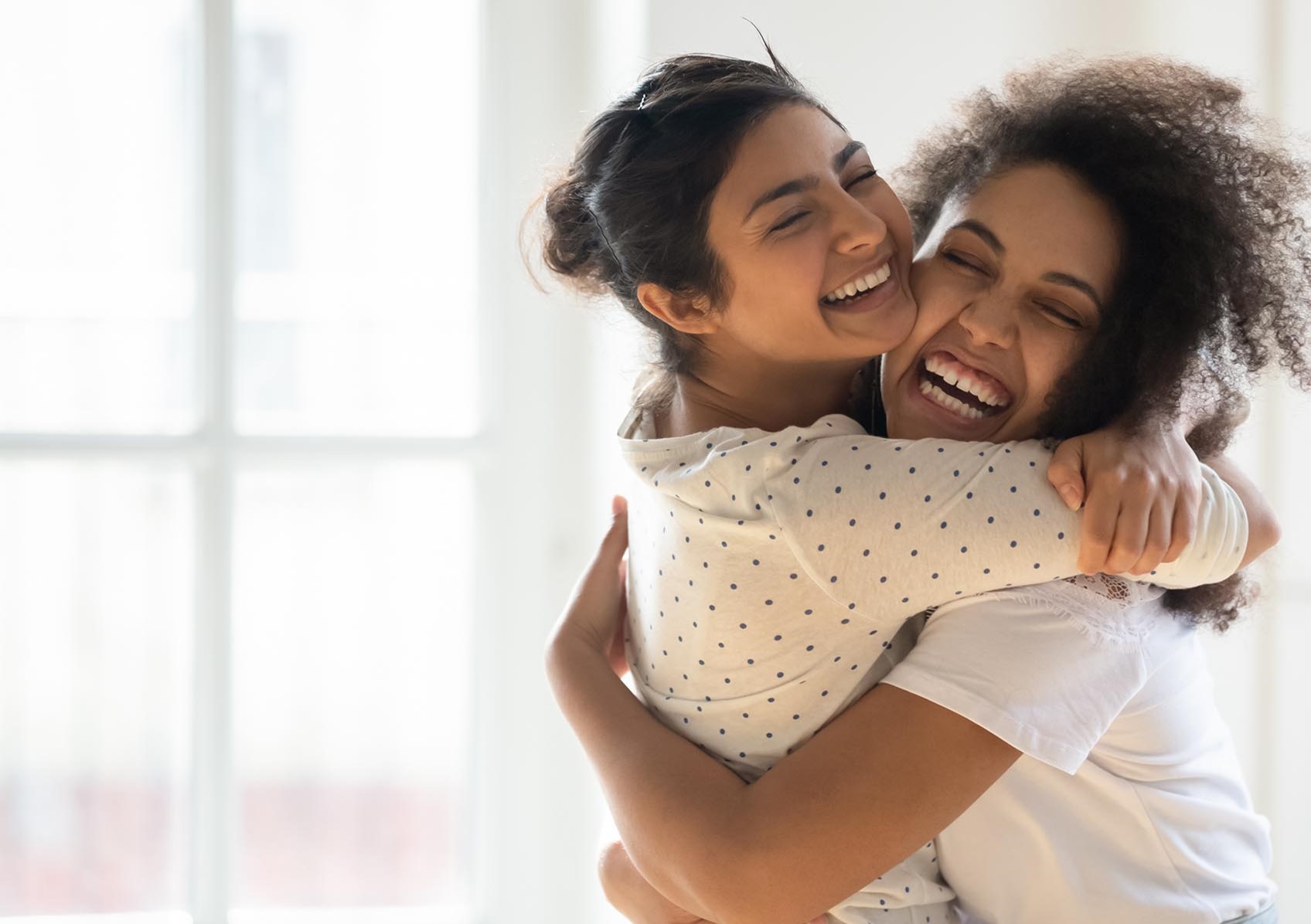 two happy girls hugging