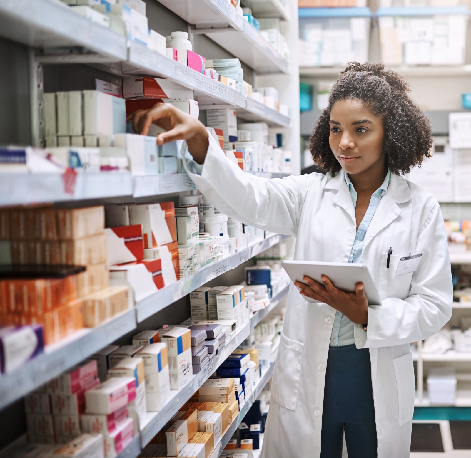 pharmacist reaching for a drug on the shelf