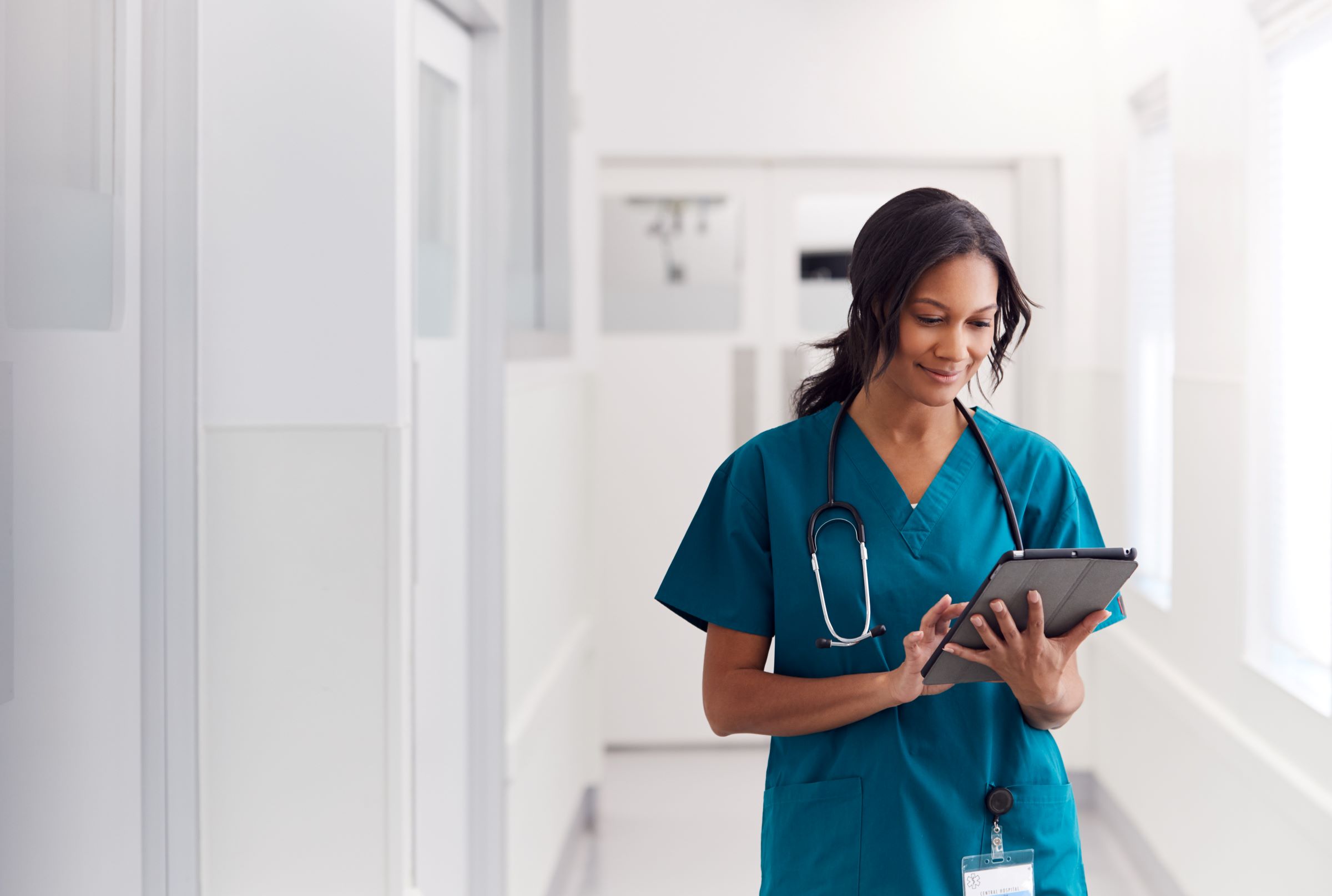 a healthcare worker reading her tablet