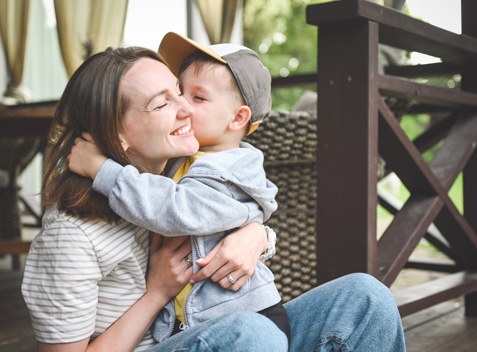 young boy hugging and kissing his mom