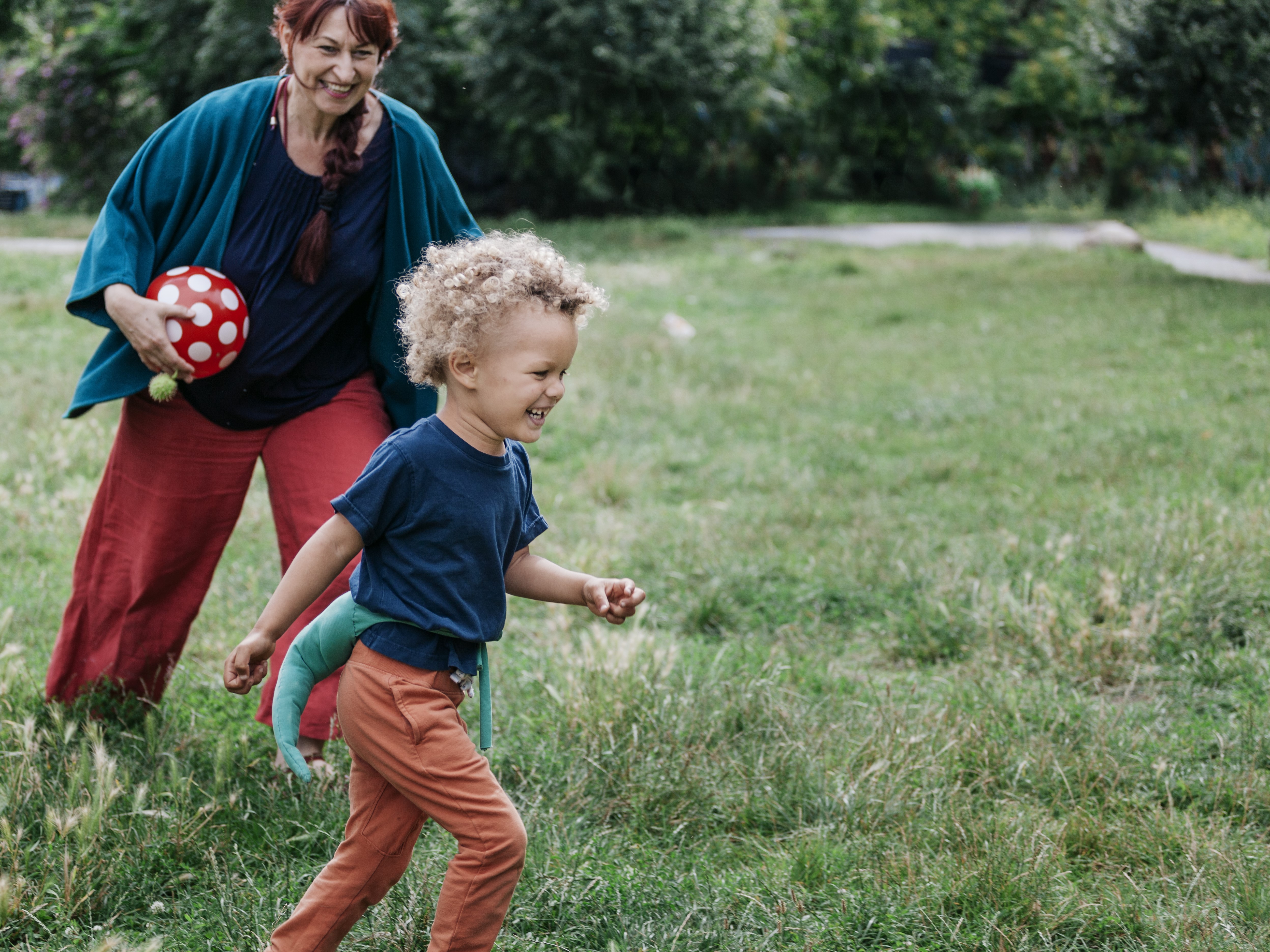 mom playfully chasing her young son