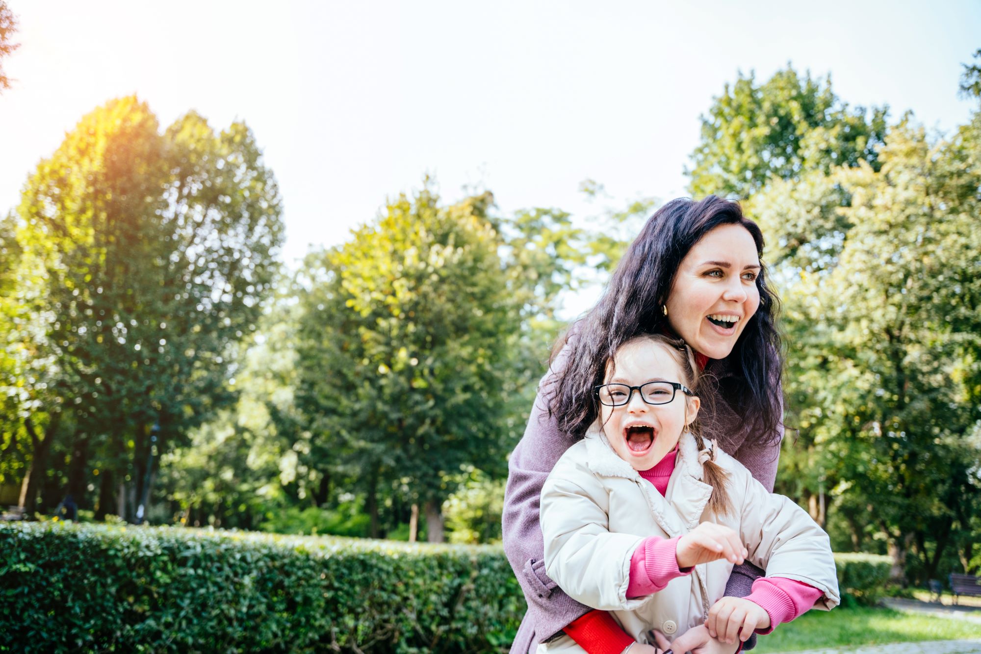 mother and young daughter laughing together