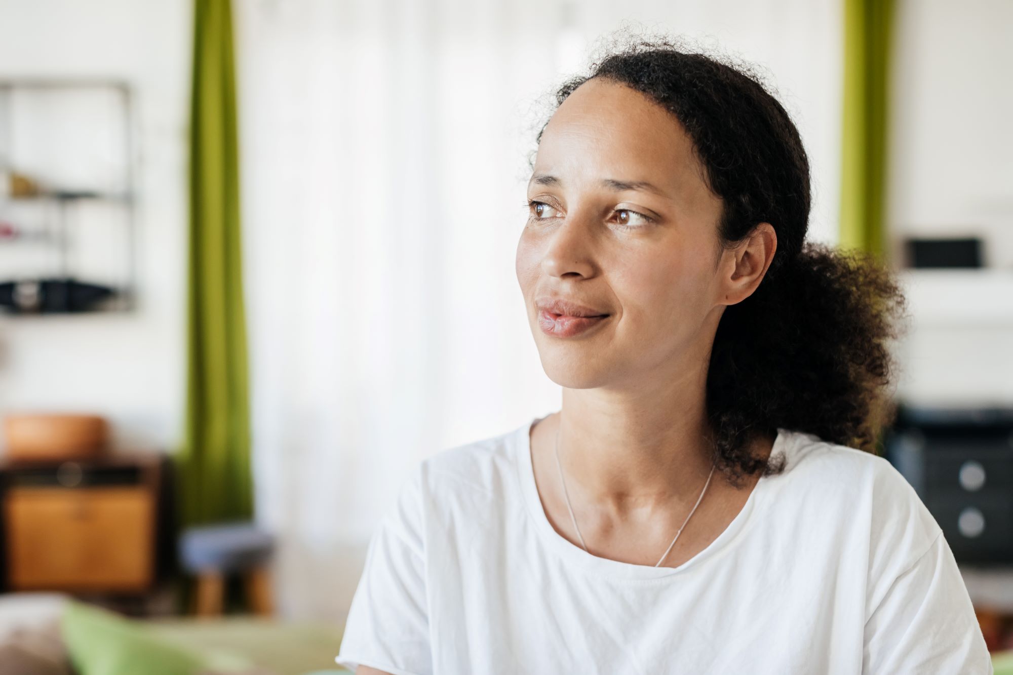 peaceful young woman looks off in the distance