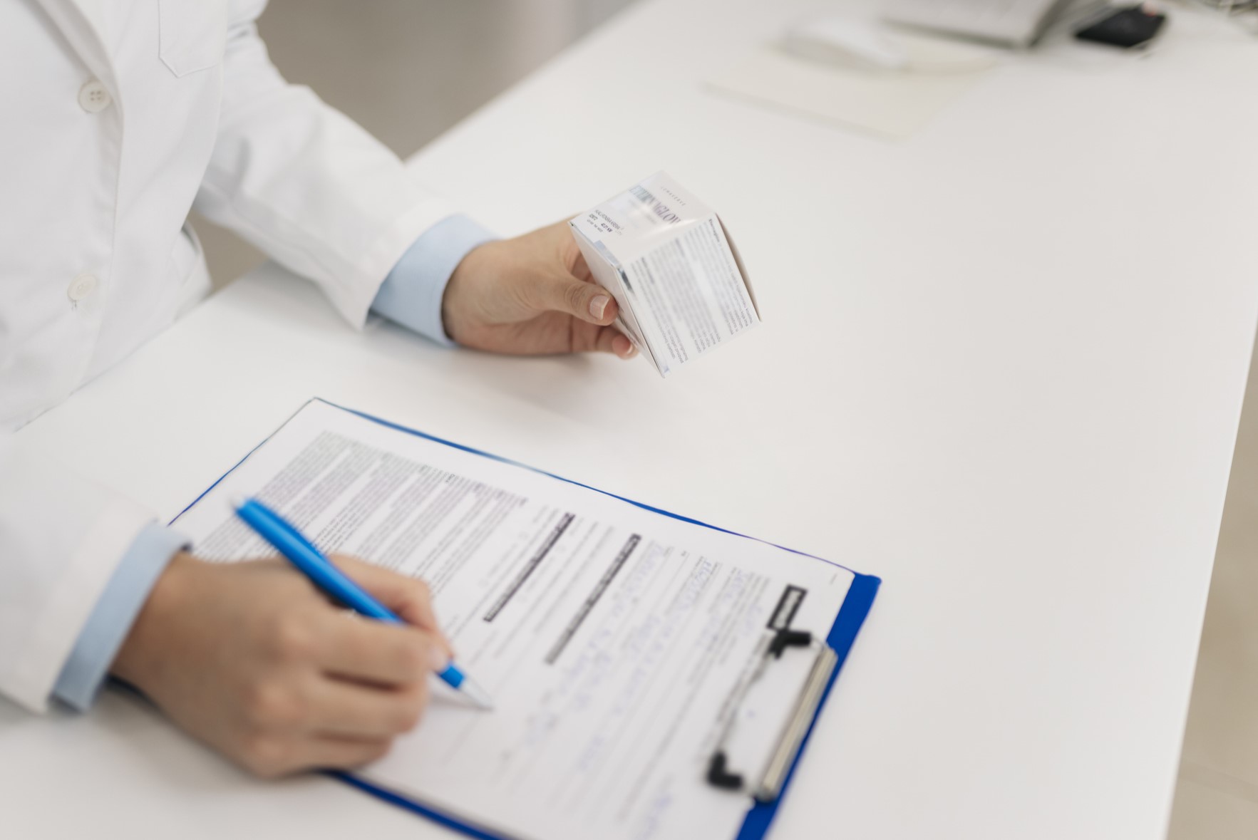 pharmacist selecting medication from a shelf