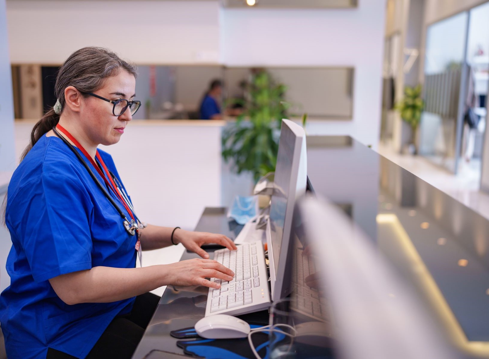 medical receptionist works at her computer